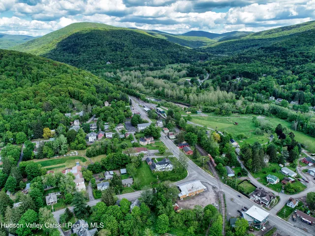 an aerial view of a house with a yard and lake view