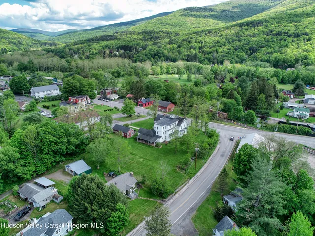 an aerial view of a house with a yard