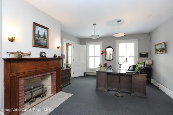 a living room with furniture a window and a fireplace