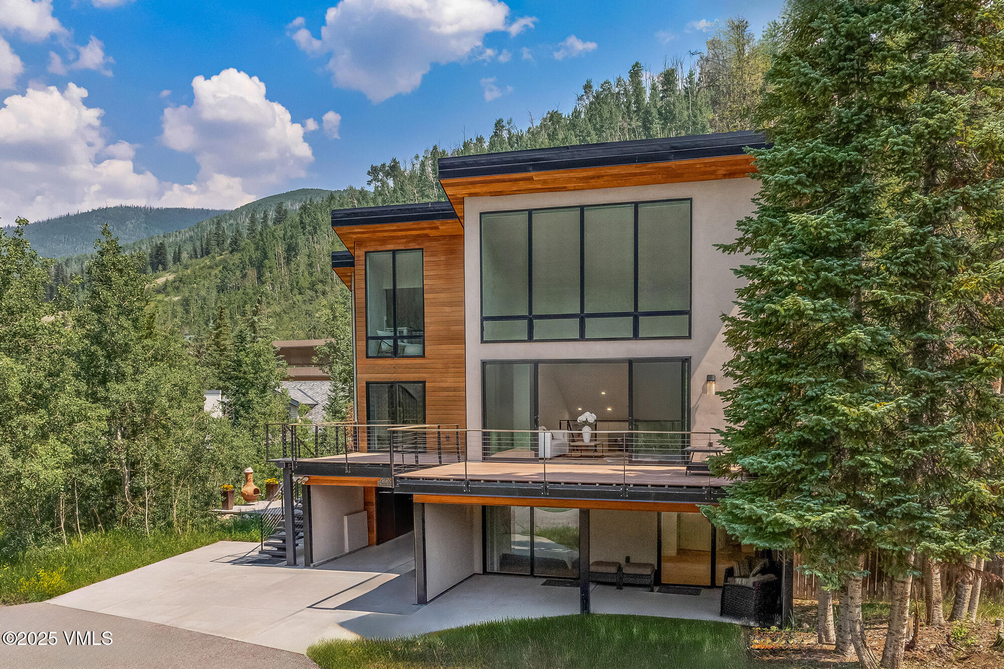 4545 Big Horn Road Vail, CO 81657 - Photo 4 of 49 a front view of a house with a yard glass top table and chairs