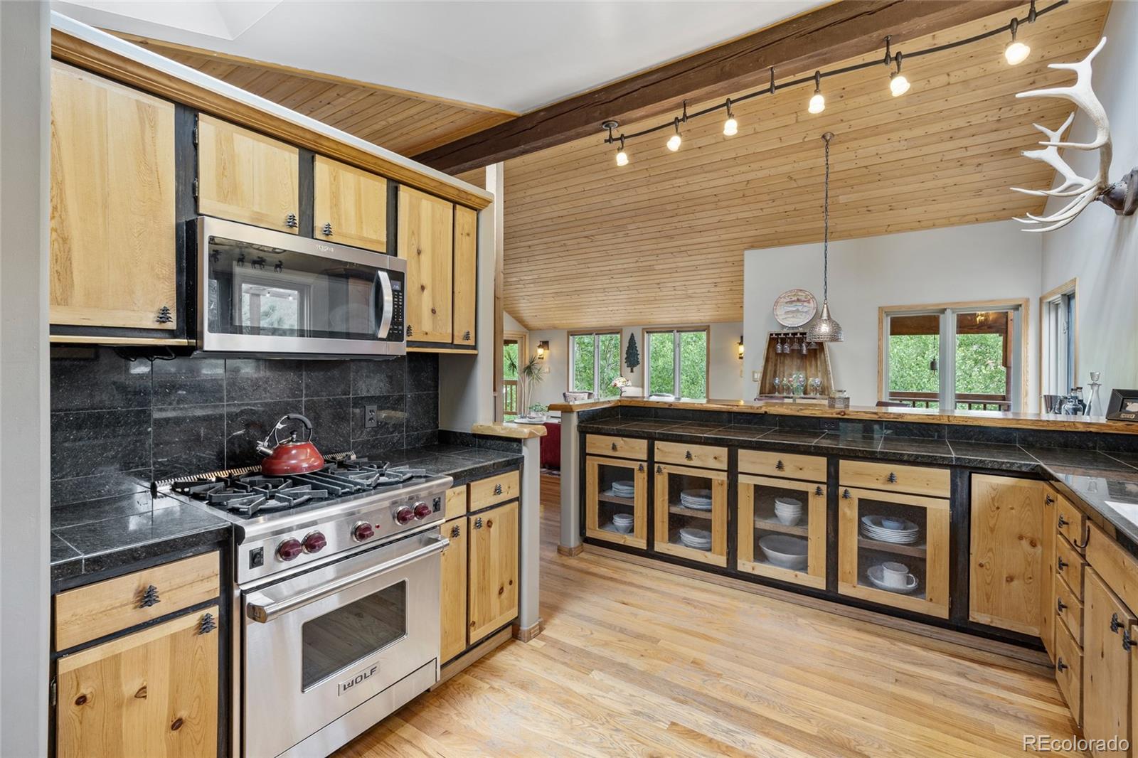 193 Twilight Terrace Drive Bailey, CO 80421 - Photo 12 of 50 a kitchen with stainless steel appliances granite countertop a stove and a microwave