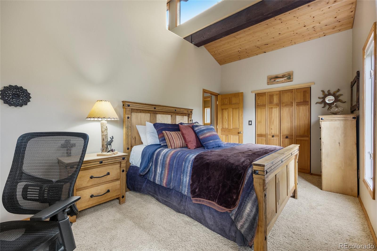 193 Twilight Terrace Drive Bailey, CO 80421 - Photo 22 of 50 a bedroom with a bed and a chair