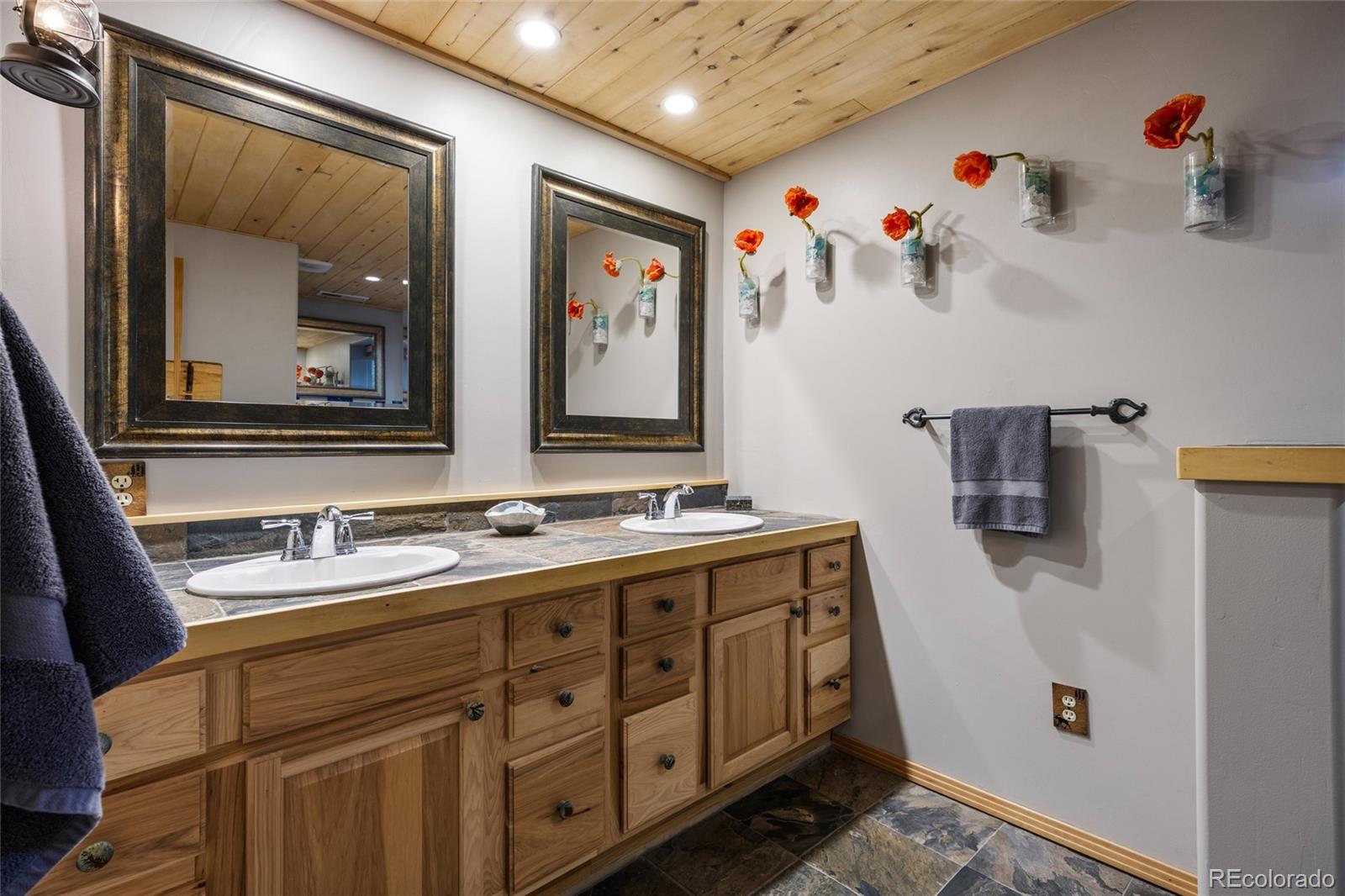 193 Twilight Terrace Drive Bailey, CO 80421 - Photo 32 of 50 a bathroom with a sink mirror and vanity