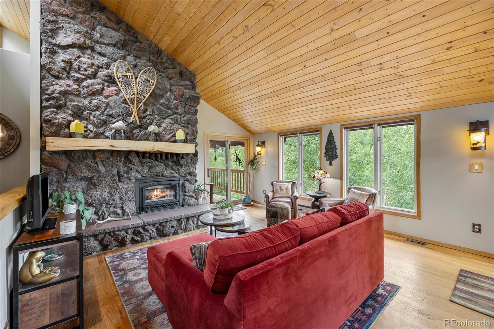 193 Twilight Terrace Drive Bailey, CO 80421 - Photo 5 of 50 a living room with furniture a fireplace and a floor to ceiling window