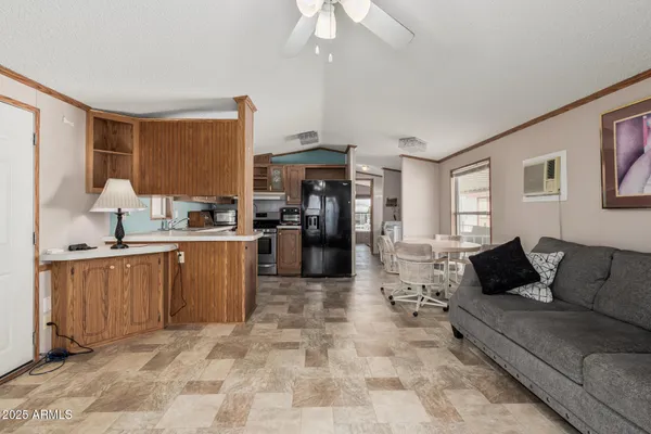 a living room with stainless steel appliances kitchen island granite countertop furniture and a kitchen view