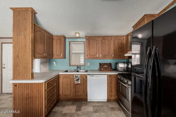 a kitchen with a sink stove and refrigerator