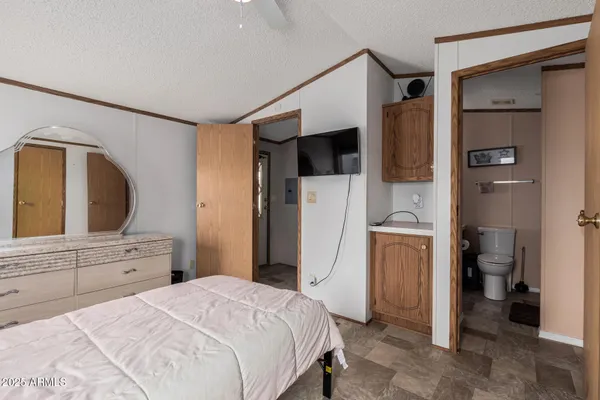 a bedroom with a bed and a view of bathroom