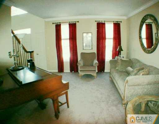 52 Stratton Road Old Bridge, NJ 07747 - Photo 2 of 8 a living room with furniture a mirror and a window