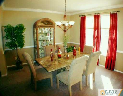 52 Stratton Road Old Bridge, NJ 07747 - Photo 3 of 8 a view of a dining room with furniture and a chandelier