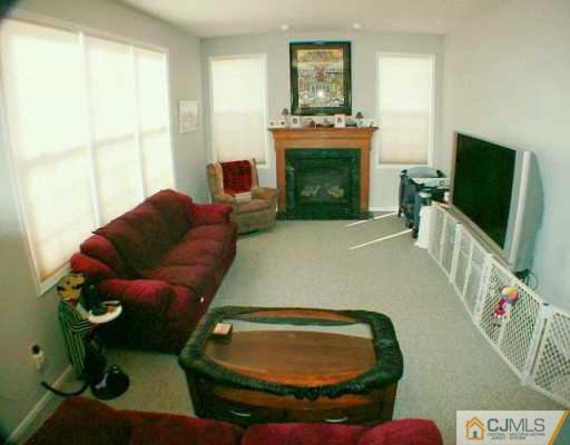 52 Stratton Road Old Bridge, NJ 07747 - Photo 4 of 8 a living room with furniture and a fireplace