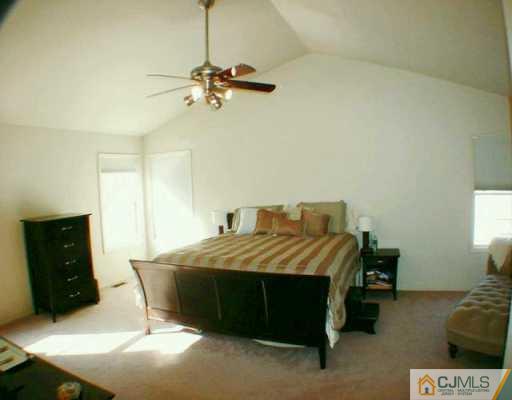 52 Stratton Road Old Bridge, NJ 07747 - Photo 5 of 8 a bedroom with a bed and a television