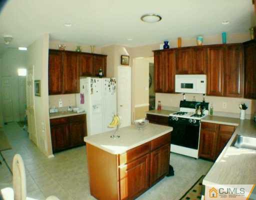 52 Stratton Road Old Bridge, NJ 07747 - Photo 7 of 8 a kitchen with a stove top oven sink and refrigerator