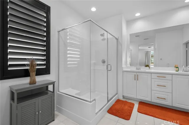 a spacious bathroom with a shower sink and mirror