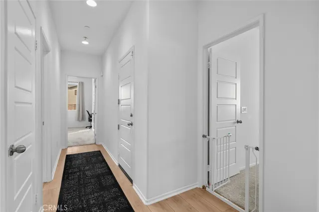 a view of a hallway with a wooden floor