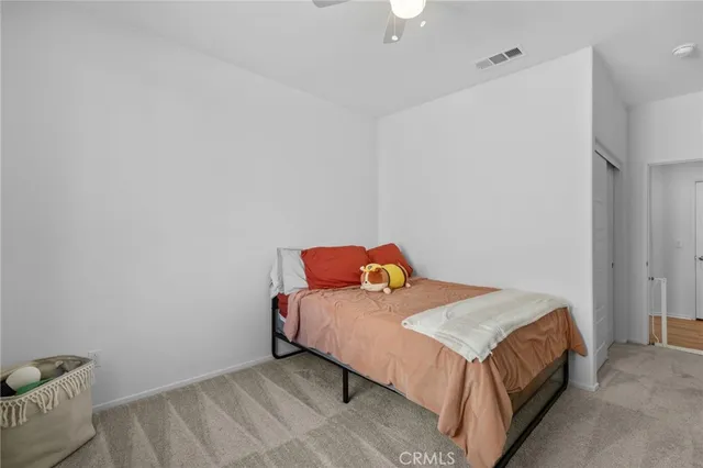 a bedroom with a bed and a couch