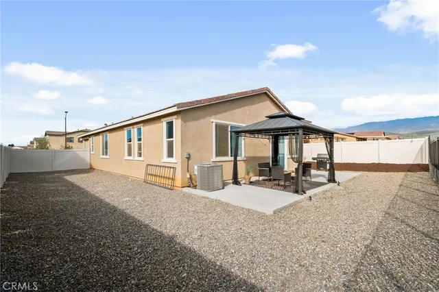 a view of a house with backyard and sitting area