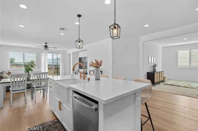 a large kitchen with a table and chairs