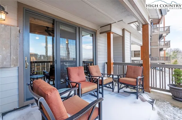 a outdoor living room with furniture and a floor to ceiling window