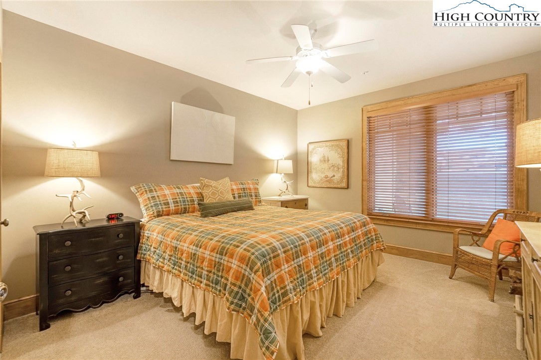 152 Red Tail Summit, Unit CI2 Boone, NC 28607 - Photo 19 of 33 a bedroom with a bed and a chandelier