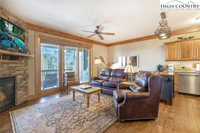 a living room with fireplace furniture and a wooden floor