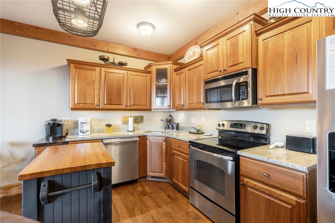 152 Red Tail Summit, Unit CI2 Boone, NC 28607 - Photo 5 of 33 a kitchen with stainless steel appliances granite countertop a sink a stove a microwave and cabinets