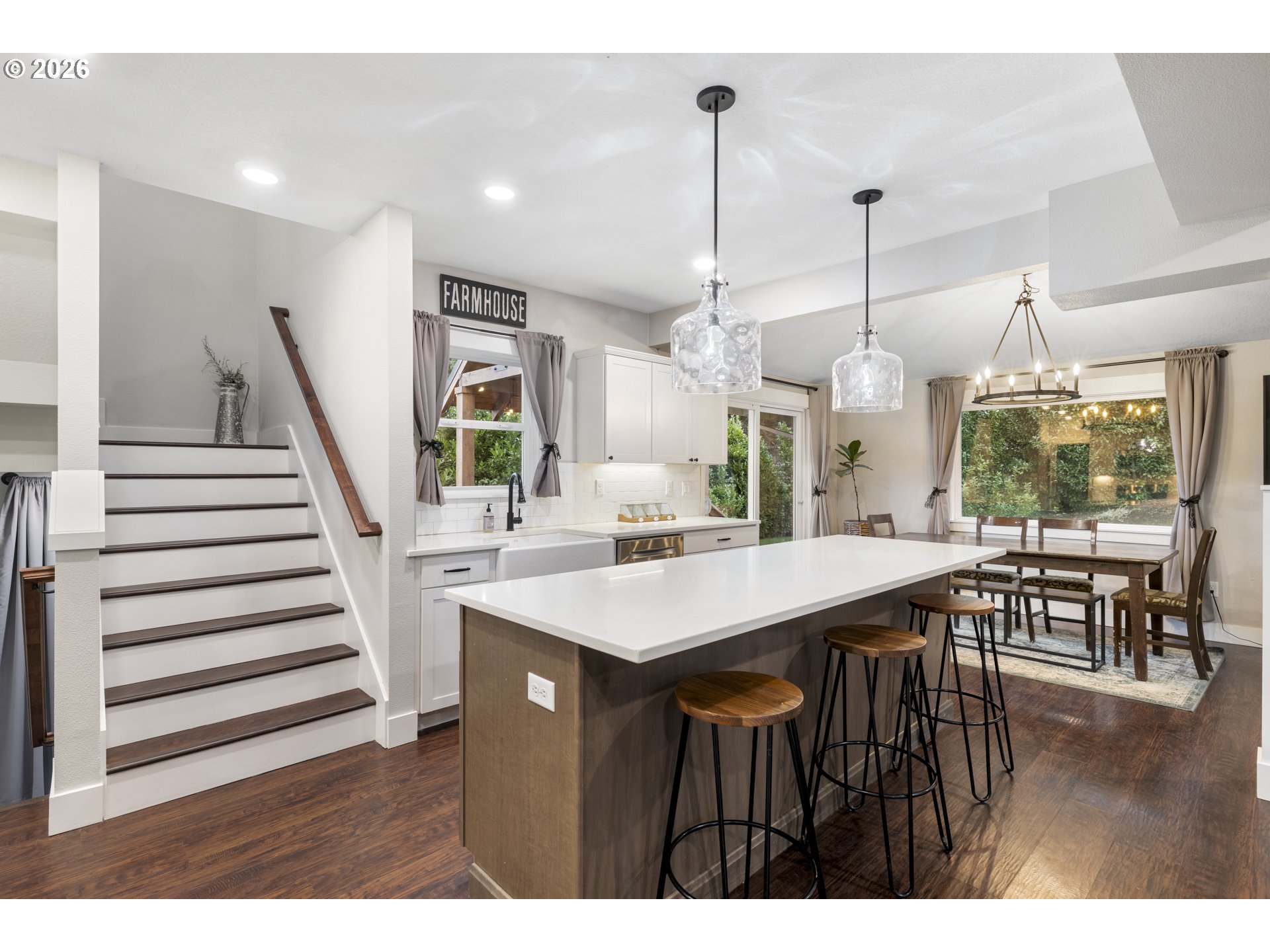 16453 Forsythe Road Oregon City, OR 97045 - Photo 13 of 48 a view of a dining room and livingroom with furniture wooden floor a chandelier