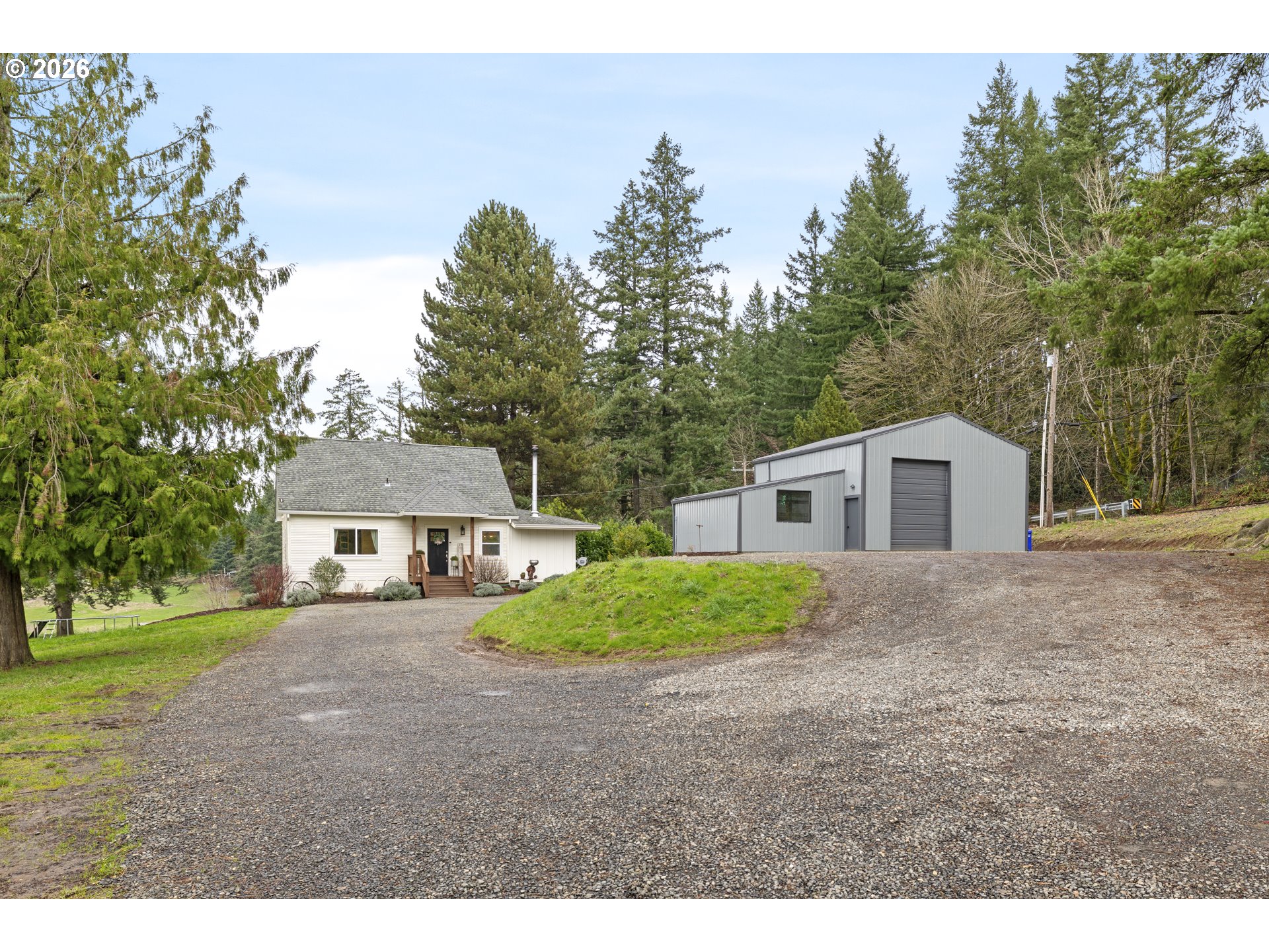 16453 Forsythe Road Oregon City, OR 97045 - Photo 8 of 48 a view of a yard in front of a house with large trees