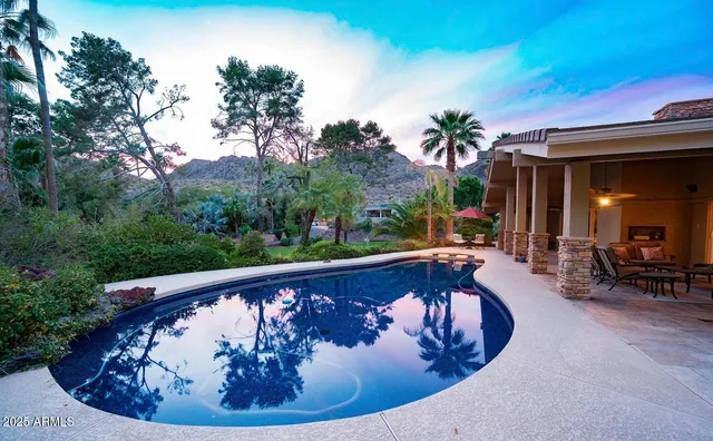 a view of swimming pool with a couches in patio