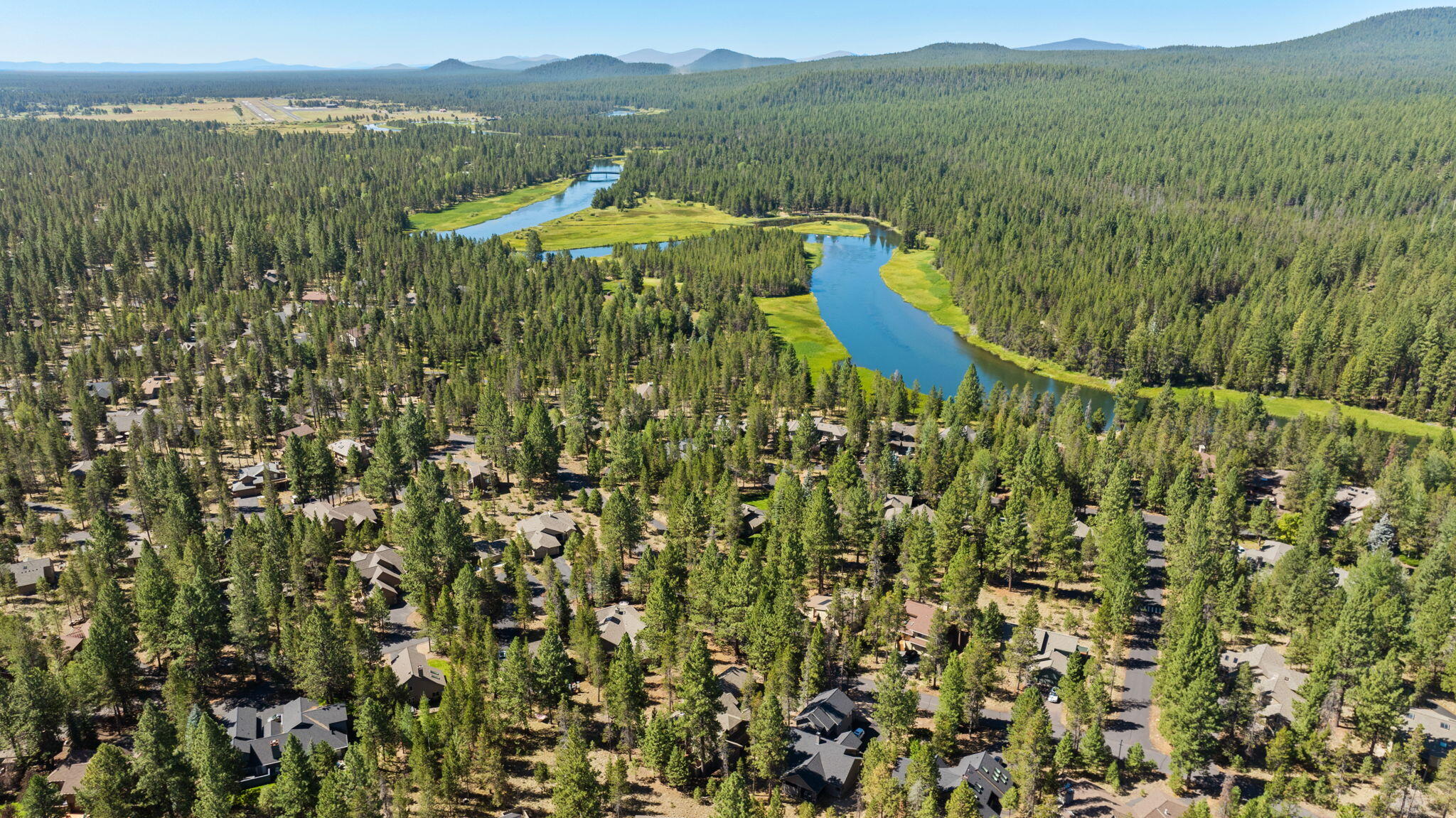58026 Kinglet Road Sunriver, OR 97707 - Photo 37 of 39 a view of a lake with a mountain in the background