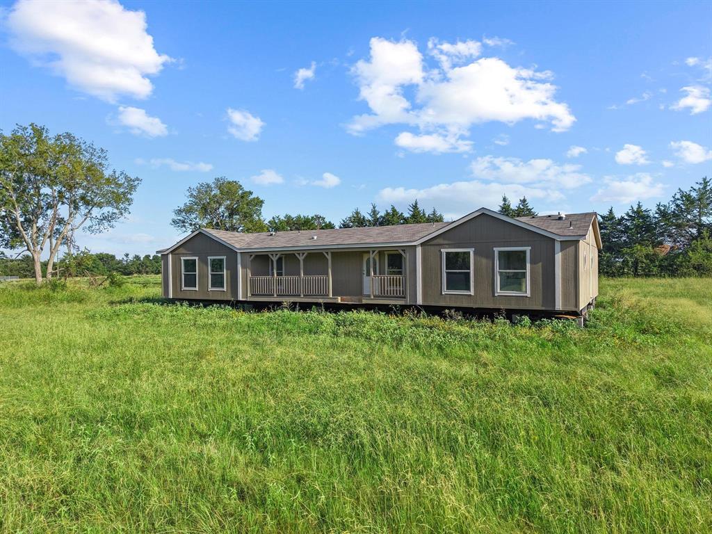 372 Hemby Way Bonham, TX 75418 - Photo 1 of 12 a front view of a house with a garden