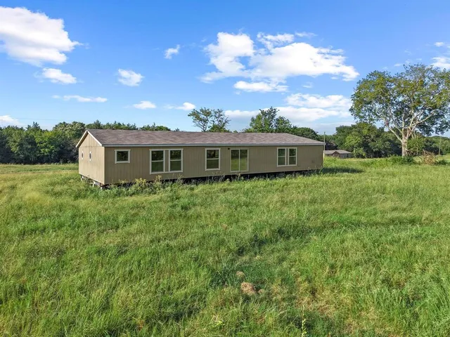 a view of a house with a big yard