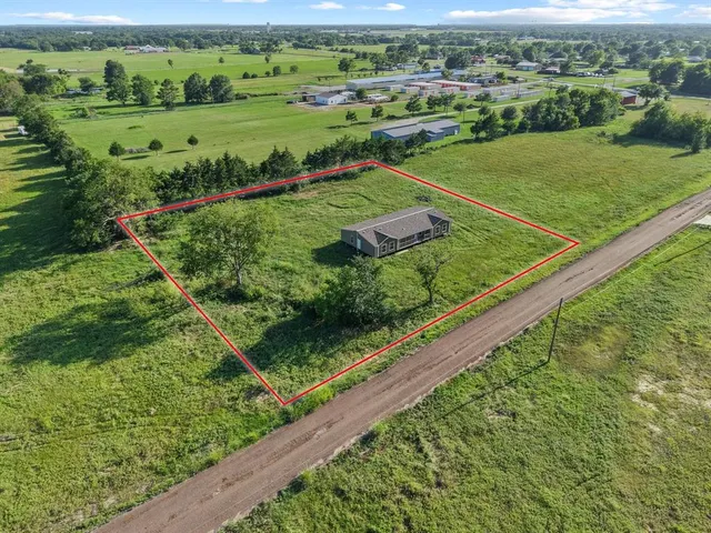 a view of a green field with sitting area