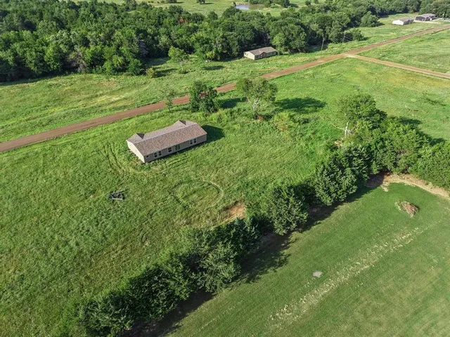 a view of a field with an trees