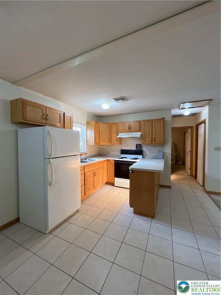 11 South Main Street, Unit 105 Nazareth, PA 18064 - Photo 2 of 10 a kitchen with stainless steel appliances granite countertop a refrigerator sink and cabinets