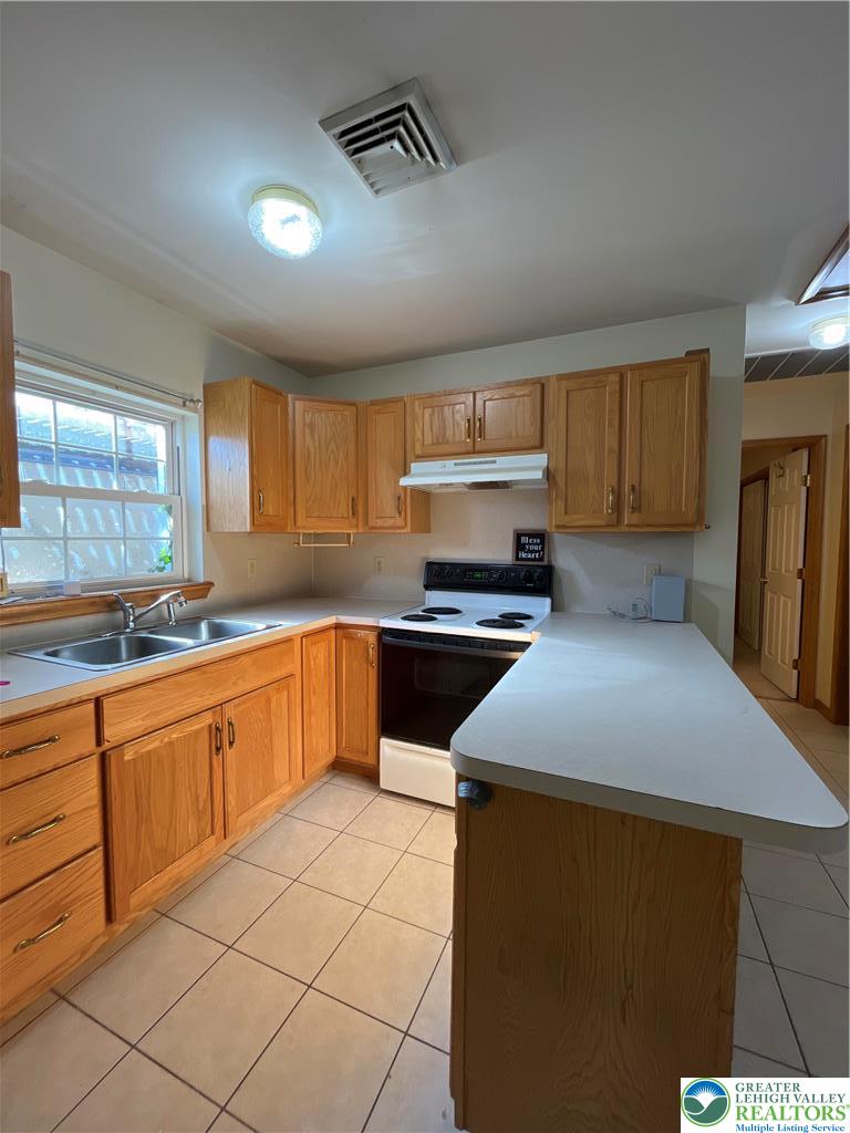 11 South Main Street, Unit 105 Nazareth, PA 18064 - Photo 3 of 10 a kitchen with stainless steel appliances a sink cabinets and a window