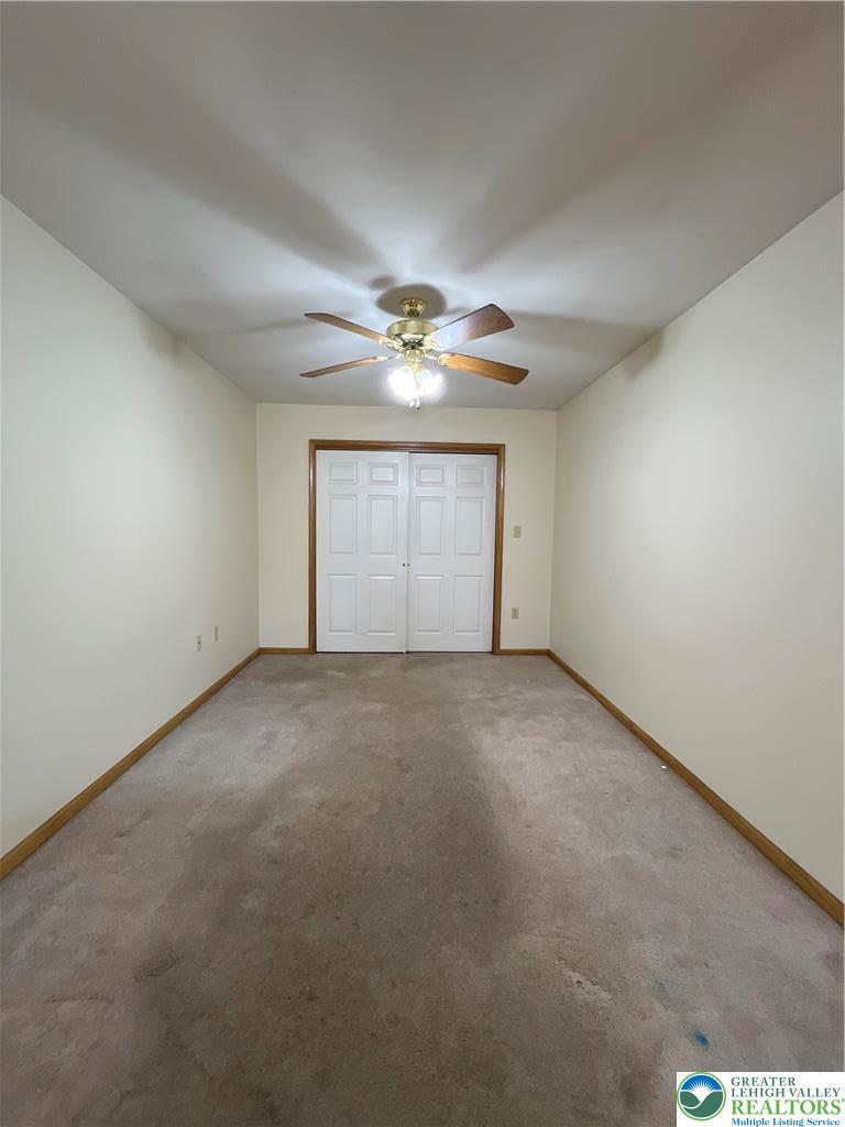 11 South Main Street, Unit 105 Nazareth, PA 18064 - Photo 5 of 10 a view of a livingroom with a ceiling fan and window