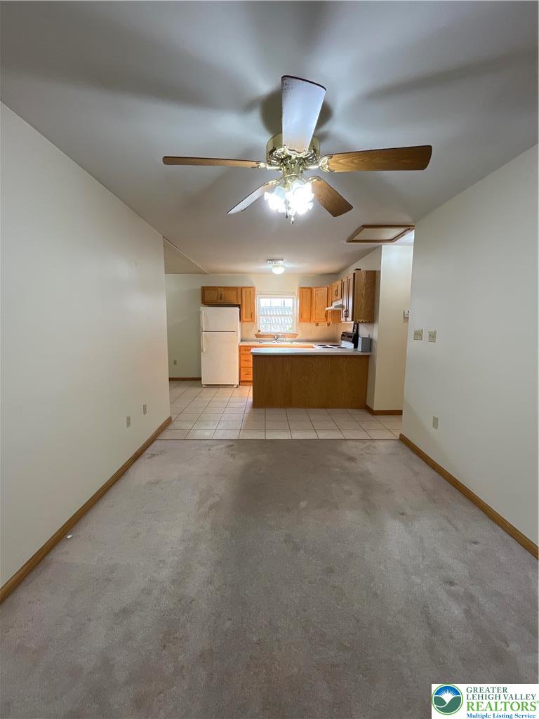 11 South Main Street, Unit 105 Nazareth, PA 18064 - Photo 6 of 10 a view of a livingroom with a ceiling fan and chandelier fan