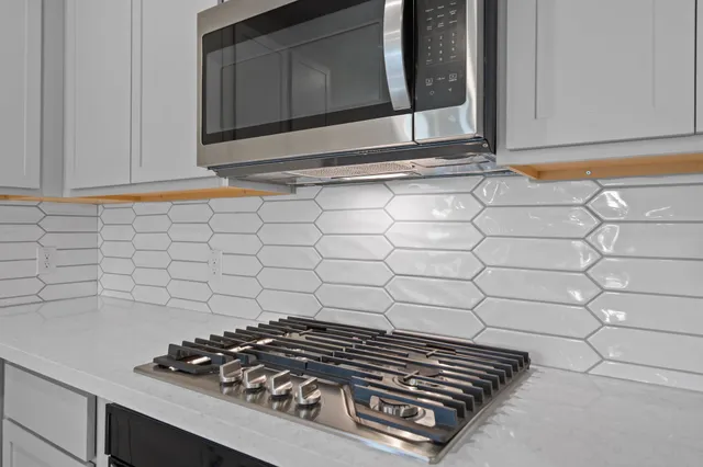 a stove top oven sitting inside of a kitchen