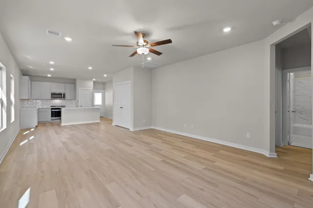 a view of an empty room with kitchen appliances