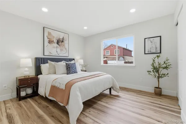 a bedroom with bed and a painting