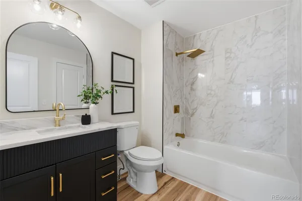 a bathroom with a toilet a sink and a bathtub