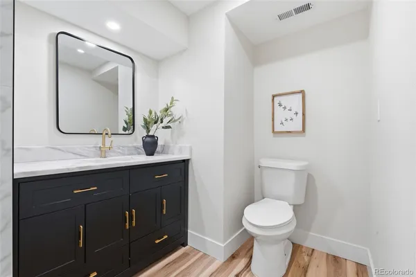 a bathroom with a toilet a sink and mirror