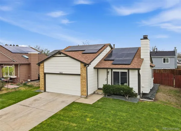 a view of a house with a yard and garage