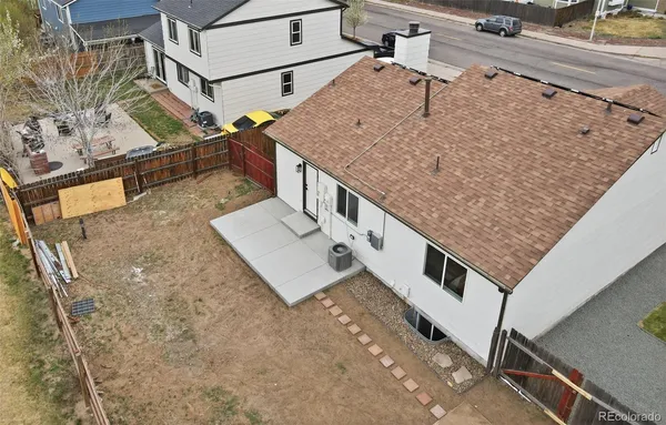 a view of a yard with wooden fence