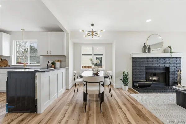 a kitchen with a table chairs refrigerator and cabinets