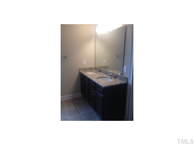 2203 Shepherd Valley Street Raleigh, NC 27610 - Photo 5 of 10 Double vanity in master bathroom with granite countertop and ceramic tile floor