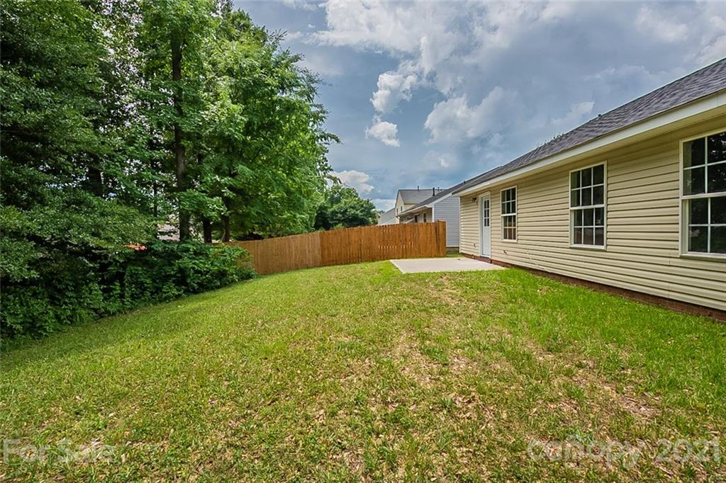 1665 Tate Road Rock Hill, SC 29732 - Photo 16 of 16 a backyard of a house with plants and large tree