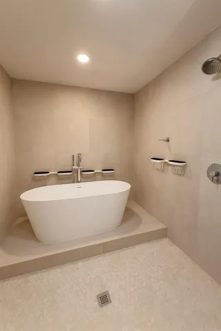 a white bath tub sitting in a bathroom