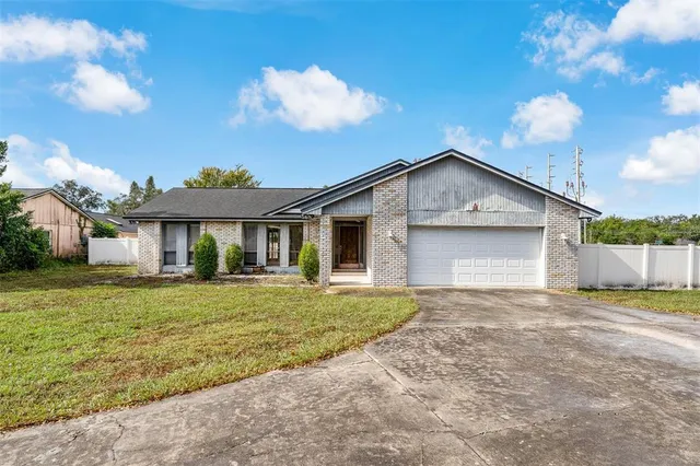a view of a house with a yard and garage