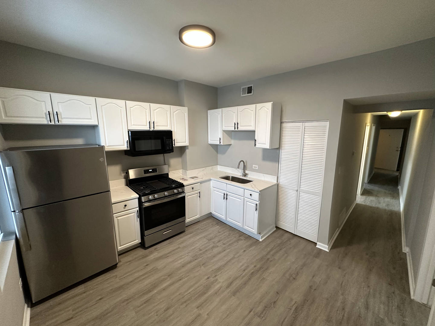 6320 South Drexel Avenue, Unit 3 Chicago, IL 60637 - Photo 1 of 13 a kitchen with a refrigerator a stove top oven a sink and dishwasher